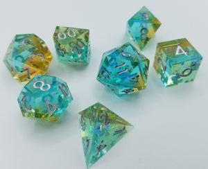 Light teal blue layer and gold top layer transparent dice with very small gold glitter throughout