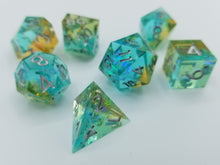 Load image into Gallery viewer, Light teal blue layer and gold top layer transparent dice with very small gold glitter throughout