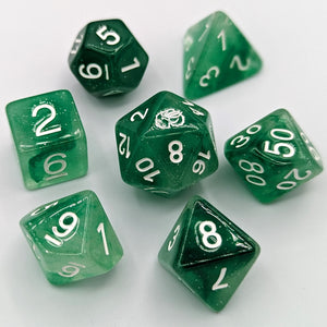 Semi transparent green dice with a mix of light to dark green pattern and slight glitter. White Font with Talys Dragon. 7 Piece Standard Size Dice Set