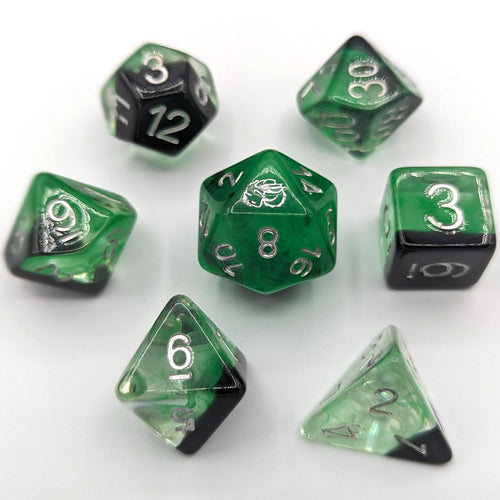 One third Solid black layer with green transparent nebula pattern creates the smoke for the cauldron. Silver Font with Talys Dragon. 7 Piece Standard Size Dice Set