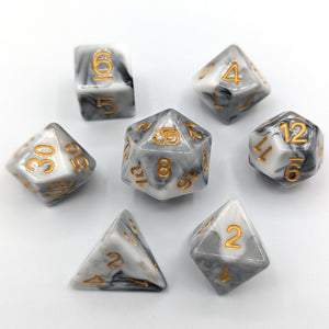 Solid white dice with grey lines going throughout like the stone. Gold font with Talys Dragon. 7 Piece Standard Size Dice Set