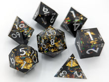 Load image into Gallery viewer, Black nebula design with most the color on one half of the dice set. Large gold flakes and multi-color flakes throughout to create a look similar to an old computer screen
