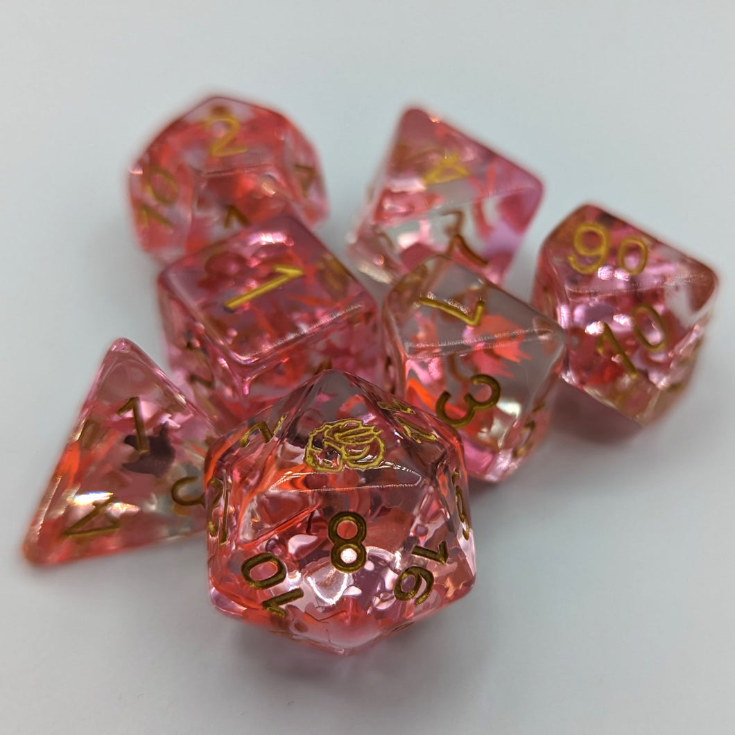 Clear dice with light and dark pink unicorn glitter. Gold font with Talys Dragon. 7 Piece Standard Size Dice Set