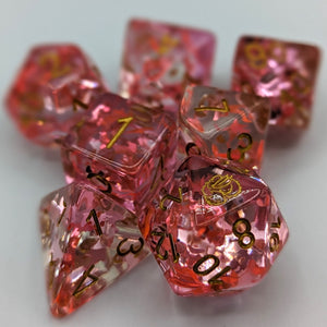 Clear dice with light and dark pink unicorn glitter. Gold font with Talys Dragon. 7 Piece Standard Size Dice Set