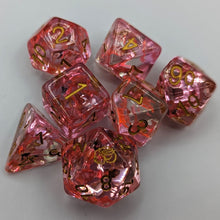 Load image into Gallery viewer, Clear dice with light and dark pink unicorn glitter. Gold font with Talys Dragon. 7 Piece Standard Size Dice Set