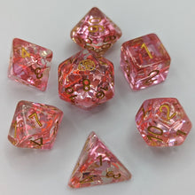 Load image into Gallery viewer, Clear dice with light and dark pink unicorn glitter. Gold font with Talys Dragon. 7 Piece Standard Size Dice Set