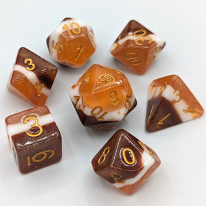 Solid color layers with chocolate brown, then marshmallow white, and graham cracker light brown. White font with Talys Dragon. 7 Piece Standard Size Dice Set