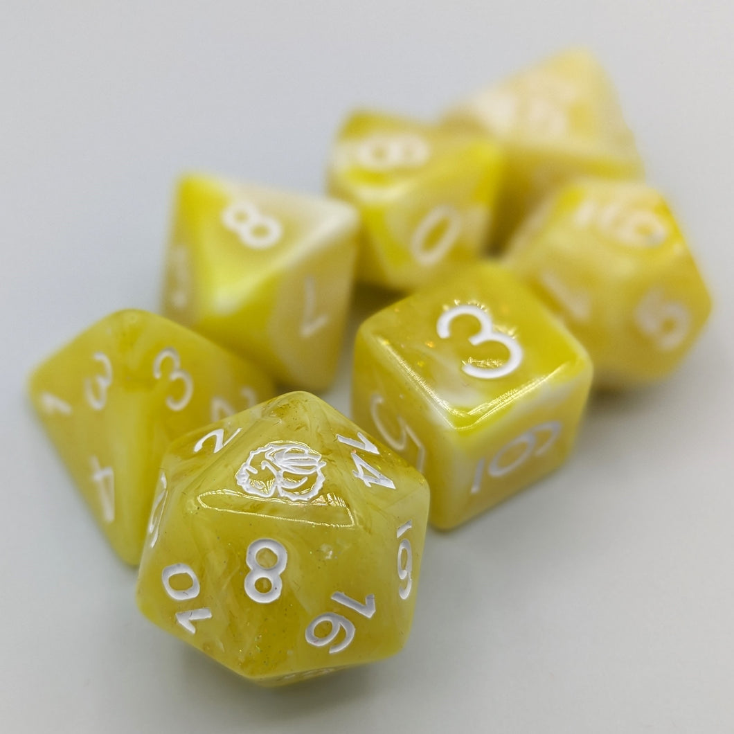 White and bright yellow marble pattern with shimmer. White font with Talys Dragon. 7 Piece Standard Size Dice Set