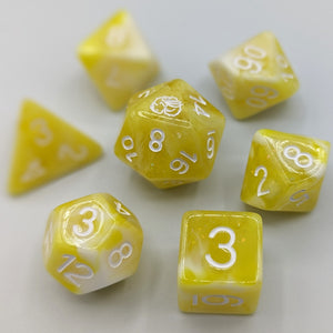 White and bright yellow marble pattern with shimmer. White font with Talys Dragon. 7 Piece Standard Size Dice Set