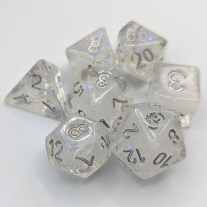 Clear dice with nebula white swirls and glitter inside creating a snow globe effect. Silver font with Talys Dragon. 7 Piece Standard Size Dice Set
