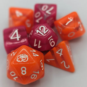 Bright orange opaque D20, D10, D8, and D4 with 2 clear stripes. Darker but vibrant pink opaque D12, D00, and D6 with 2 clear stripes. White font with Talys Dragon. 7 Piece Standard Size Dice Set